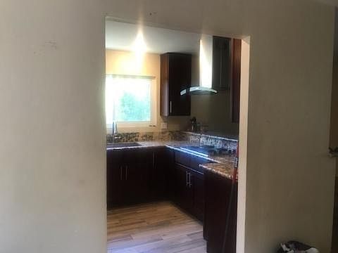 Remodel kitchen with granite counter top.
