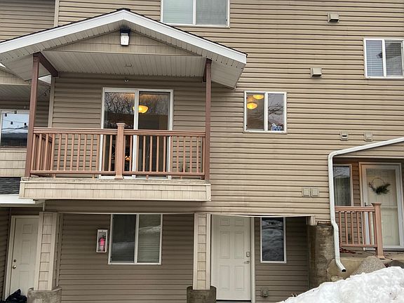 Lower level exterior entrance from parking lot and upper balcony.