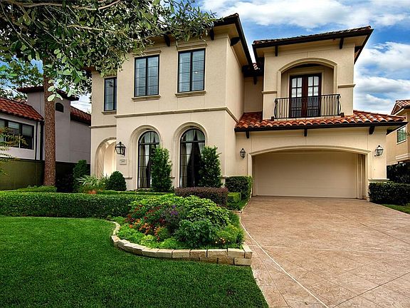 Landscape pots are placed in the landscaping throughout the grounds. The grounds are fenced with iron and hardy plank. This home's exterior is post card beautiful!