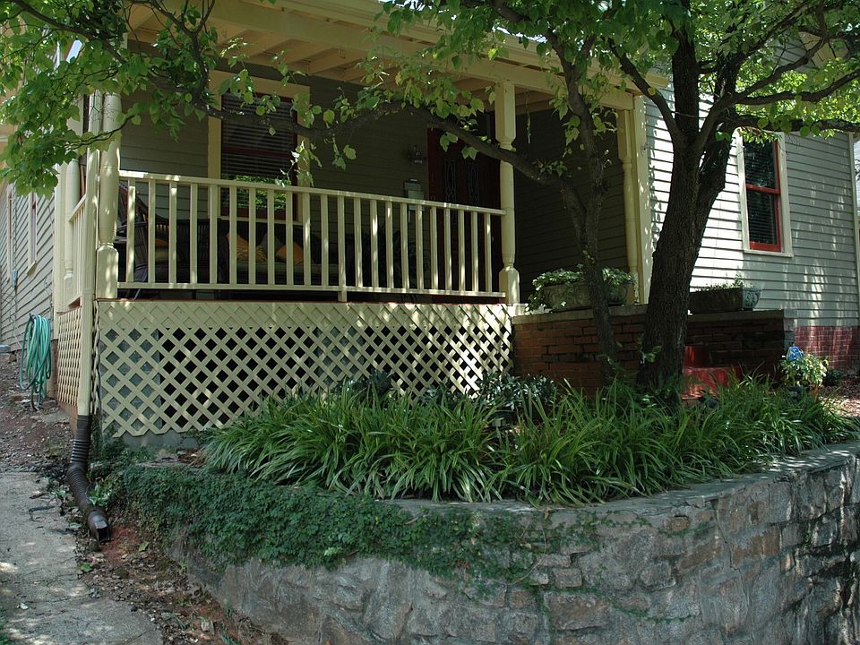 View of front of house with great sitting porch...the dogwood tree is amazing!