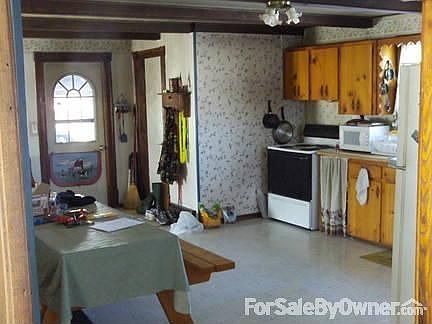 kitchen : view from dining room, shows door from garage