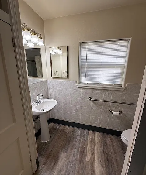 Handicap friendly bathroom, newer flooring and brand new shower, hardware, glass enclosure and toilet