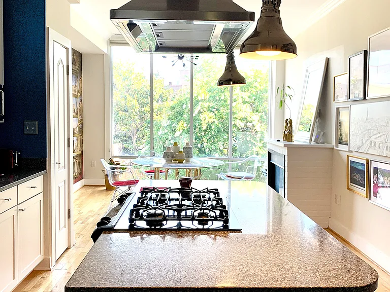 The open kitchen with center island is perfect for entertaining whether you're hosting for coffee, cocktails, or a dinner party!