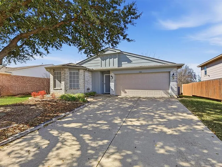 Ranch-style home with a garage, concrete driveway, and brick siding