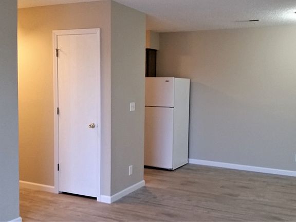View from living area to dining on right and hall and kitchen on left