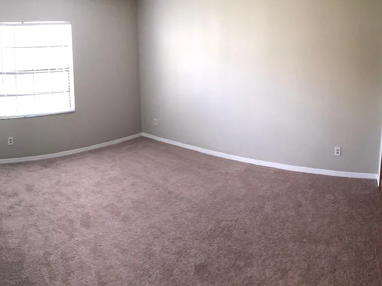 View front entry door to spacious master bedroom.
