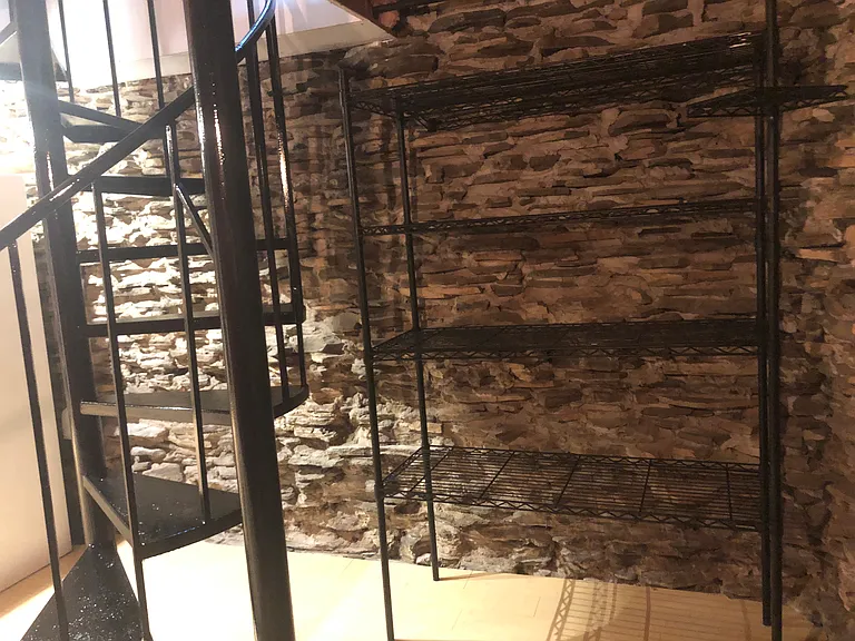 Extra shelving behind stairs - great for pantry items or kitchen storage
