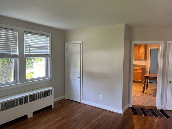 Coat closet, neutral paint, gas hot water radiator heat