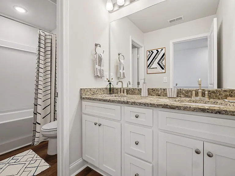 Secondary suite bathroom with a tub and shower combination