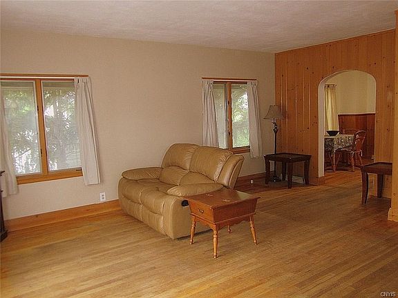 The Greatroom could easily accommodate a large sectional with room to spare!  Perfect for entertaining just about any sized gathering!  Freshly painted walls & ceiling and features the REAL original hardwood flooring.
