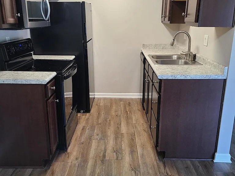 Kitchen is equipped with dishwasher, garbage disposal, microwave, self-cleaning range and refrigerator with ice maker.