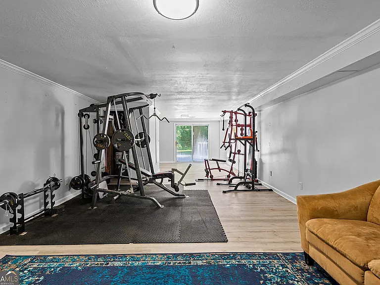 Basement with private entrance (sliding doors) to backyard and two entrances to garage. Half bath in rear
