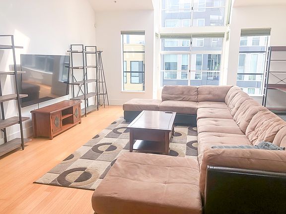2nd Floor: Sun flooded main Living Area with Fireplace, TV, Couch, Coffee Table etc. (Can come unfurnished)