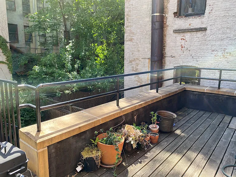 outside deck overlooks backyard on first floor