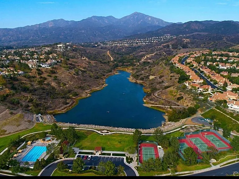Ariel view of pool, tennis courts overlooking Dove Canyon reservoir with stunning views.