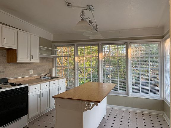 Kitchen with two walls of window and an island