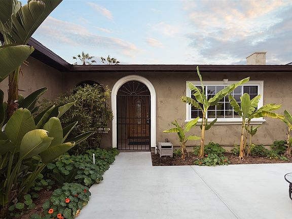 Check out the decorative, private and secure wrought iron gate and decorative architectural window and door trim detail.