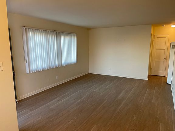 Spacious Living Room Showing window facing Condon Avenue and entry to Hall with a linen closet.