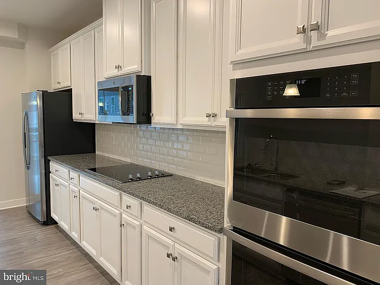 Kitchen Wall with appliances and cabinets