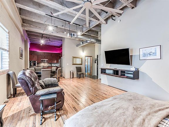 The sliding barn-styled door to the right leads to the HUGE storage room/closet. It encompasses the entire area behind the TV as well, and goes all the way up to the cement ceiling. You could use it for not only storage, but office space if you wishe