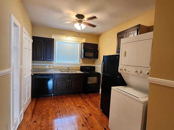 Kitchen with stacked washer and dryer