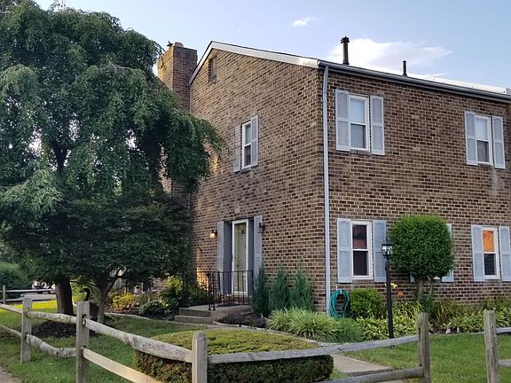 Front entry and yard, view from assigned parking space, comes with 2 parking permits. Landscaping maintenance included.