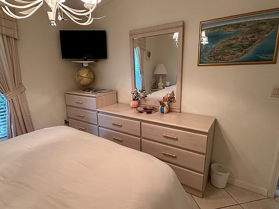 First bedroom - view #2. (Note: all bedrooms have ceiling fans and wall mounted TVs)