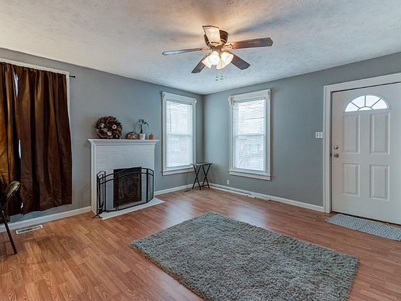 Living Room Fresh paint, wood burning fireplace, and new floor