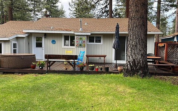 back yard with deck, hot tub and outdoor shower