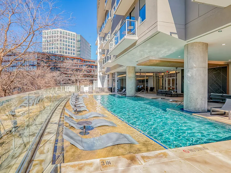 Resort style pool with lounging chairs