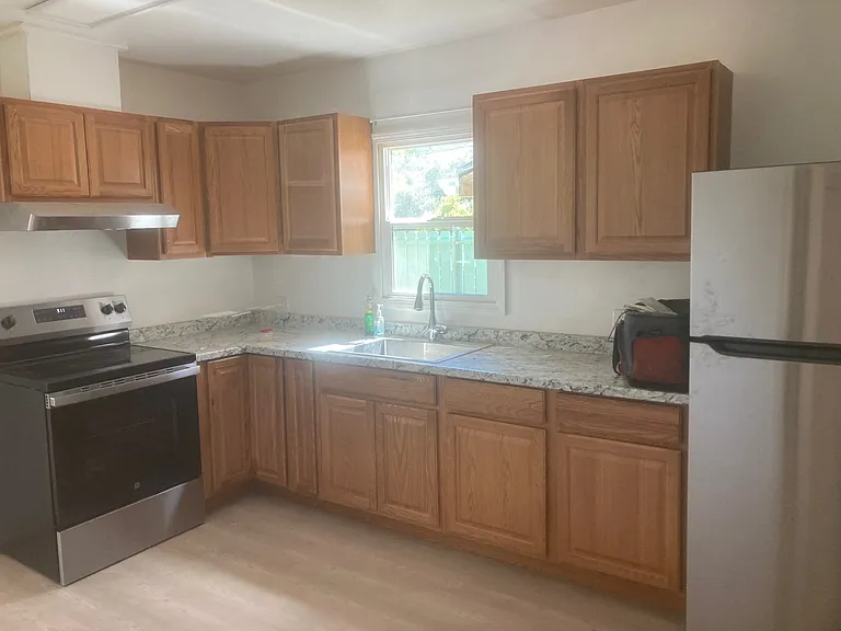A view of the kitchen from the Northwest corner. Notice all the storage space along with an exhaust fan vented through the roof.