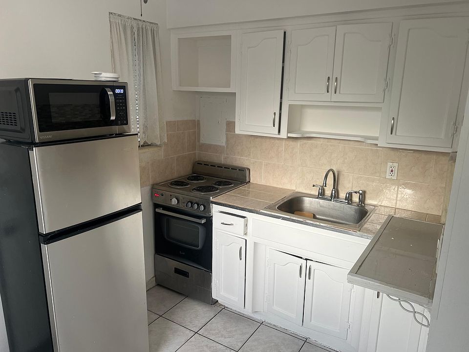 Kitchen view with stove, oven, refrigerator and microwave.