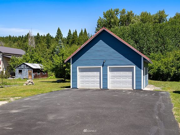 Paved driveway leads to oversized 2 car garage.>