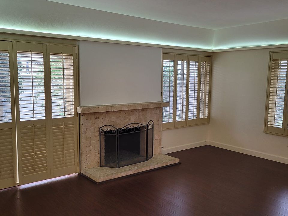 Cozy fireplace in the living room and access to a private patio. A light filled living room with a pretty coved ceiling