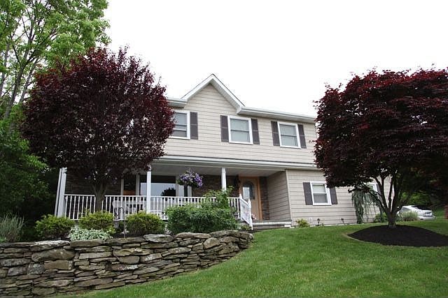 Beautiful curb-appeal! New vinyl siding, and paver walkway.