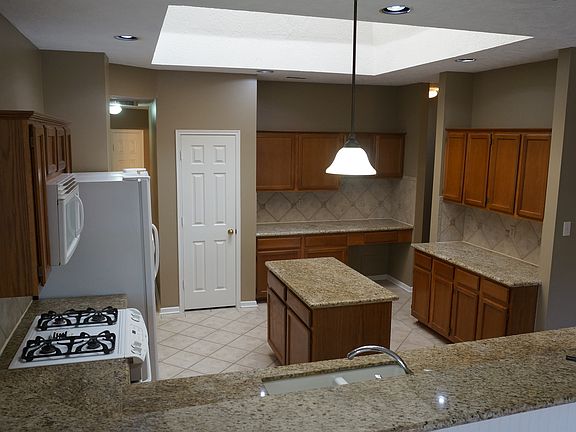 Kitchen has granite counter tops and tons of cabinet space.