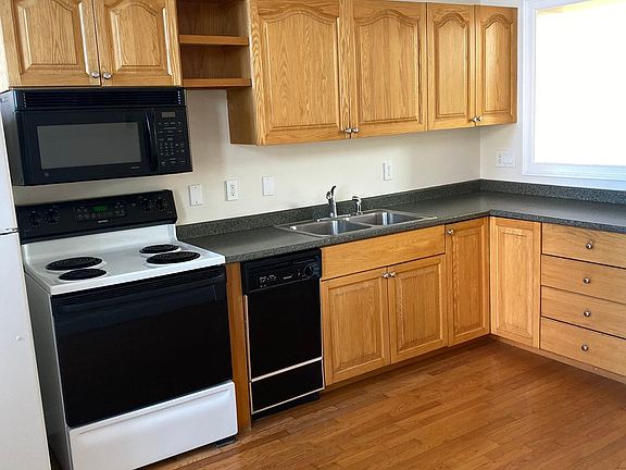 Kitchen complete with refrigerator, microwave, stove, and dishwasher.