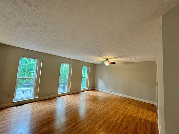 Spacious and bright living room with ceiling fan