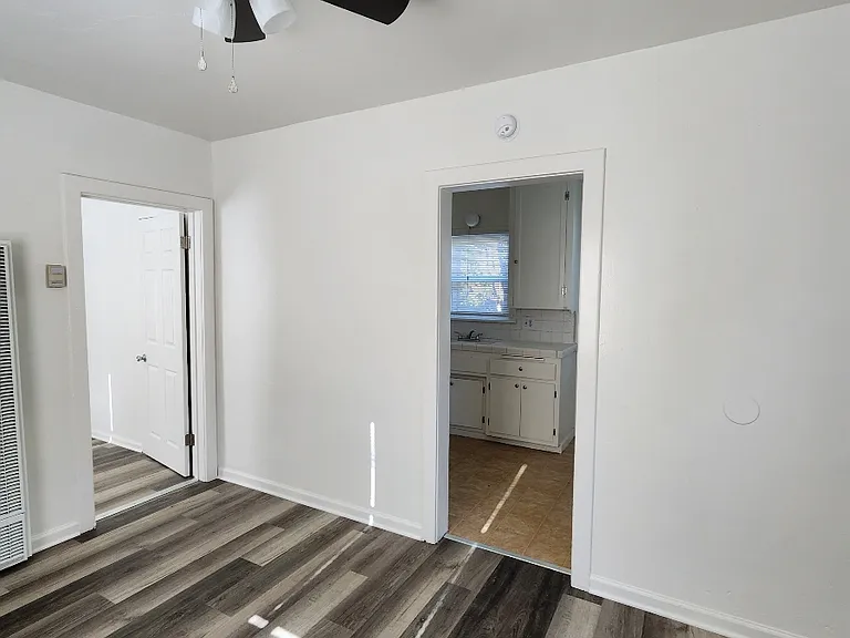 living room with ceiling fan & new vinrl flooring