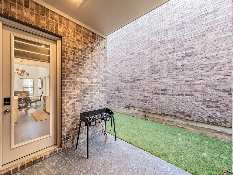 covered patio with access to a private outdoor space