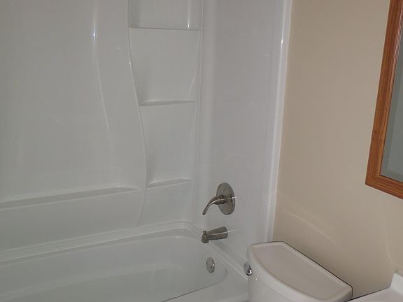 Brand new tub and shower surround, new toilet and vanity