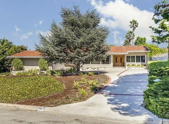 One level home with red tile roof