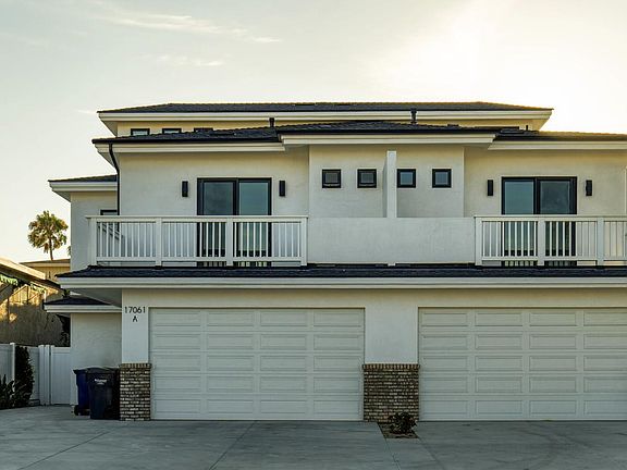 Front of home shows Unit A on the left, Unit B on the right. Nearly identical layouts. Maximum privacy with quality construction. Notice custom windows and decks above the garage..