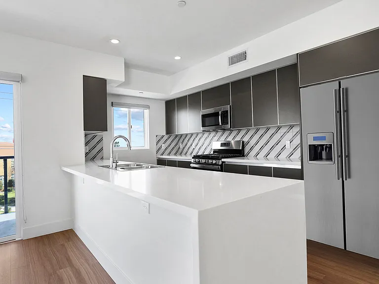 Kitchen with Energy-Efficient Refrigerator and Countertop Bar