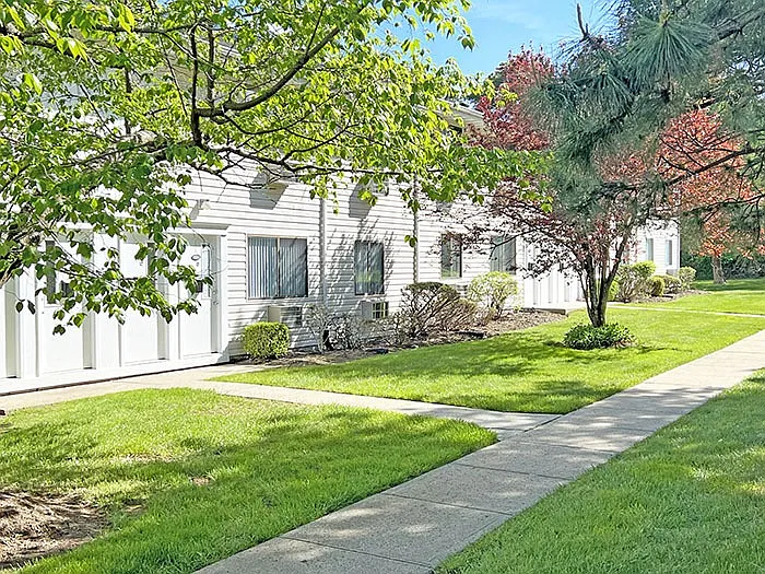 Lush green lawn area in front of apartments