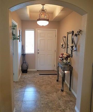 Front entry has high ceiling and beautiful tile.