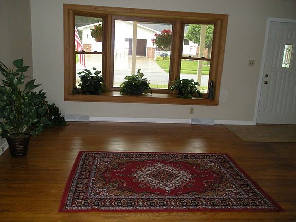 Living room with bay window and hardwood floors