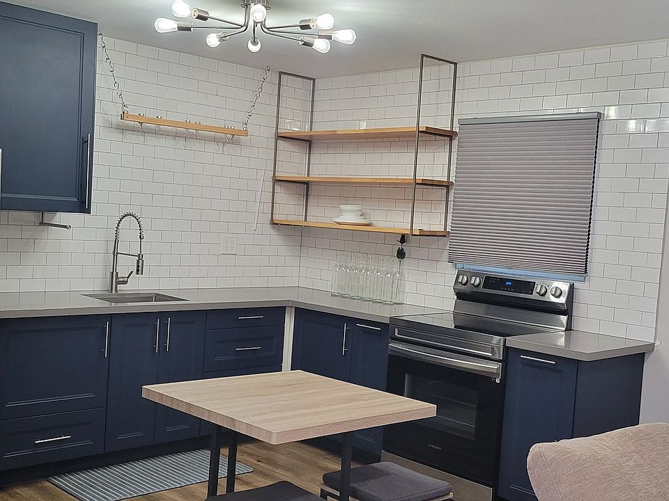 Kitchen with new stainless steel appliances (2022)
Custom open shelving and a floating pot rack.