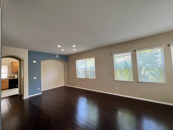 Great room with strand-woven bamboo flooring, plentiful light and windows with wood blinds