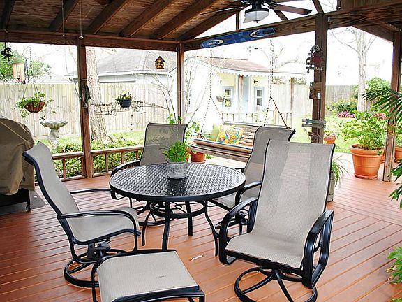Covered back patio with ceiling fans.